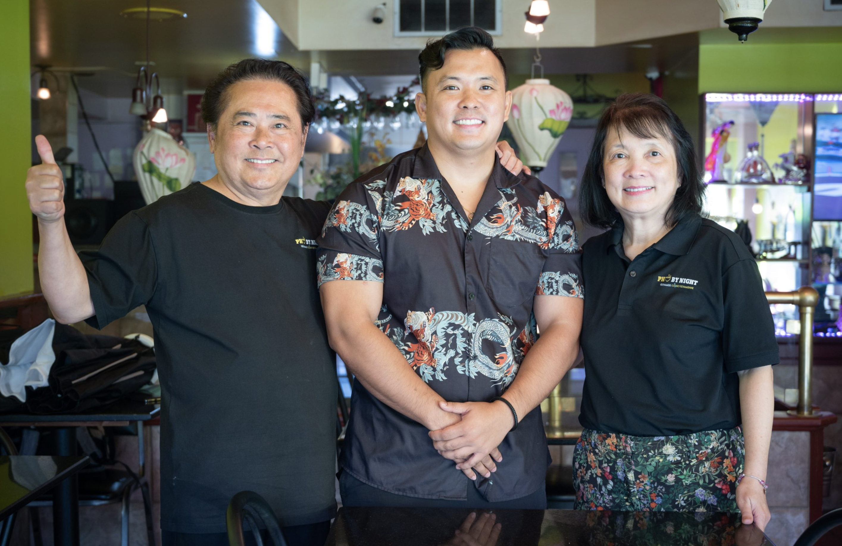 The Pho By Night family - founders An Van and Nga Luu with their son at their Vietnamese restaurant in Ottawa